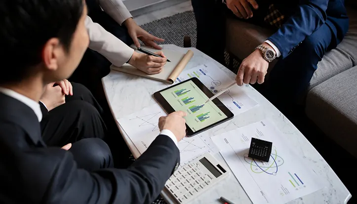 Investment team reviewing charts on a tablet